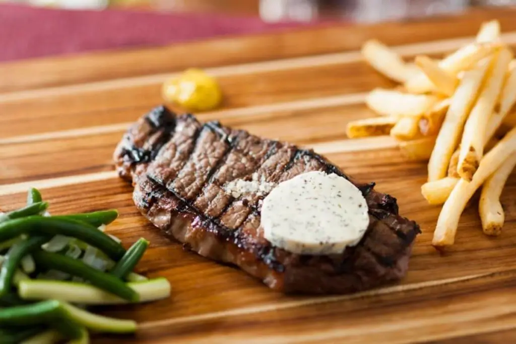 Closeup of a steak, fries, and green beans from Be Our Guest restaurant at Disney World's Magic Kingdom theme park.