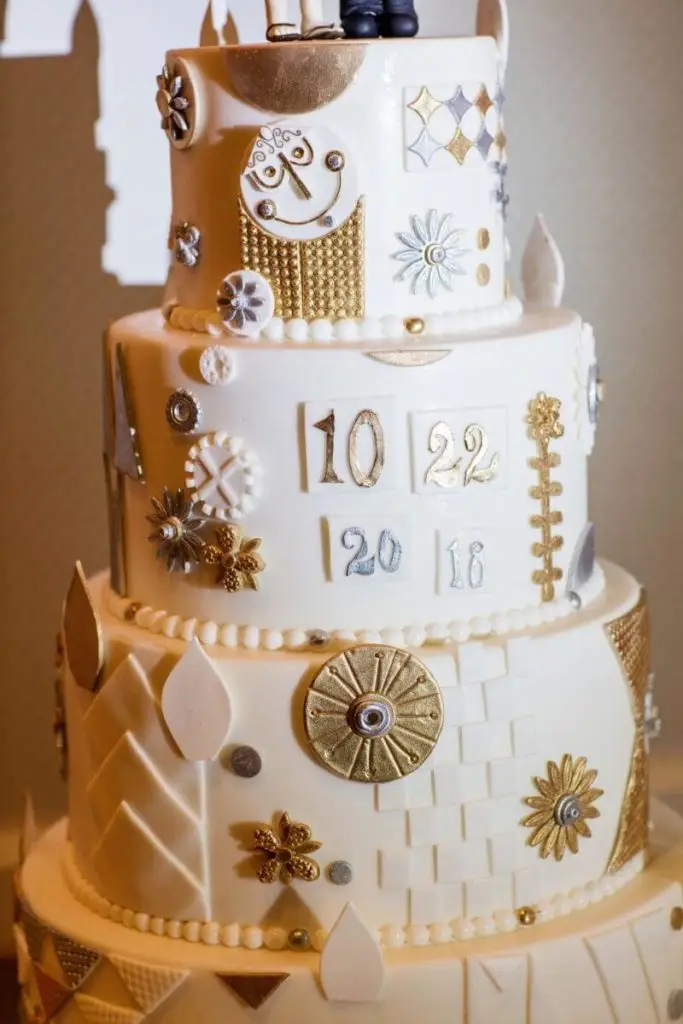 Closeup of a wedding cake with designs inspired by Disney's classic ride, It's a Small World.