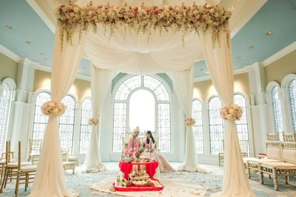 Photo of an Indian couple posing inside the wedding pavilion at the Grand Floridian Resort at Disney World.
