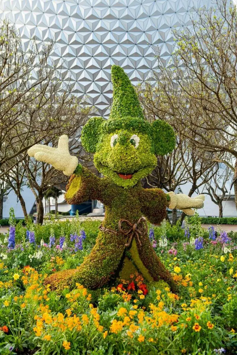 Photo of the monorail riding through Epcot with an elaborate floral display below.