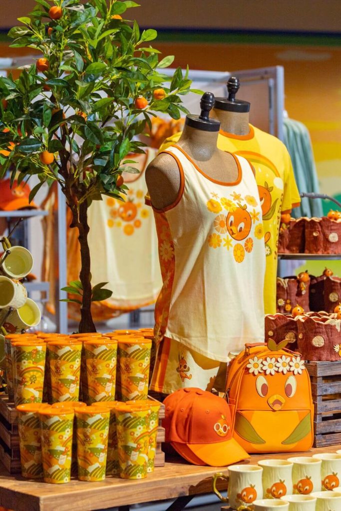 Photo of Epcot Flower and Garden Festival merchandise for 2023, including the orange bird Loungefly backpack, hats, mugs, and more.