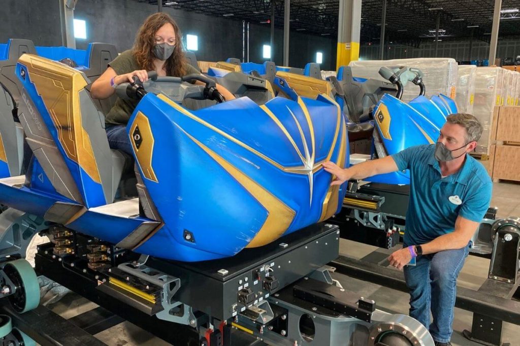 Photos of people inspecting a roller coaster car.