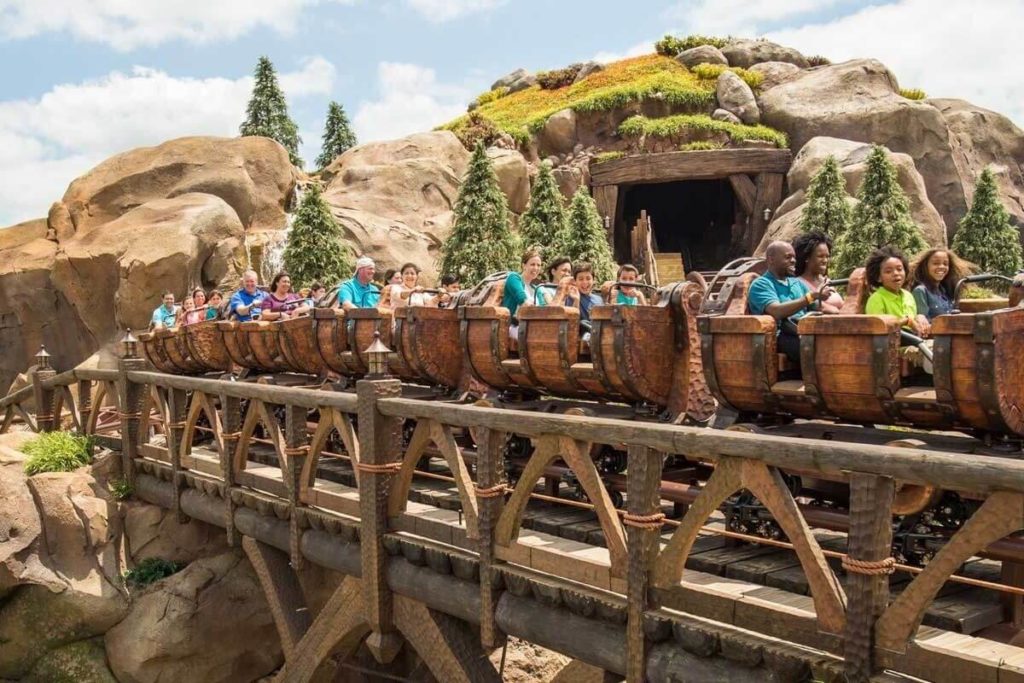Photo of guests riding the Seven Dwarfs Mine Train roller coaster at Magic Kingdom.