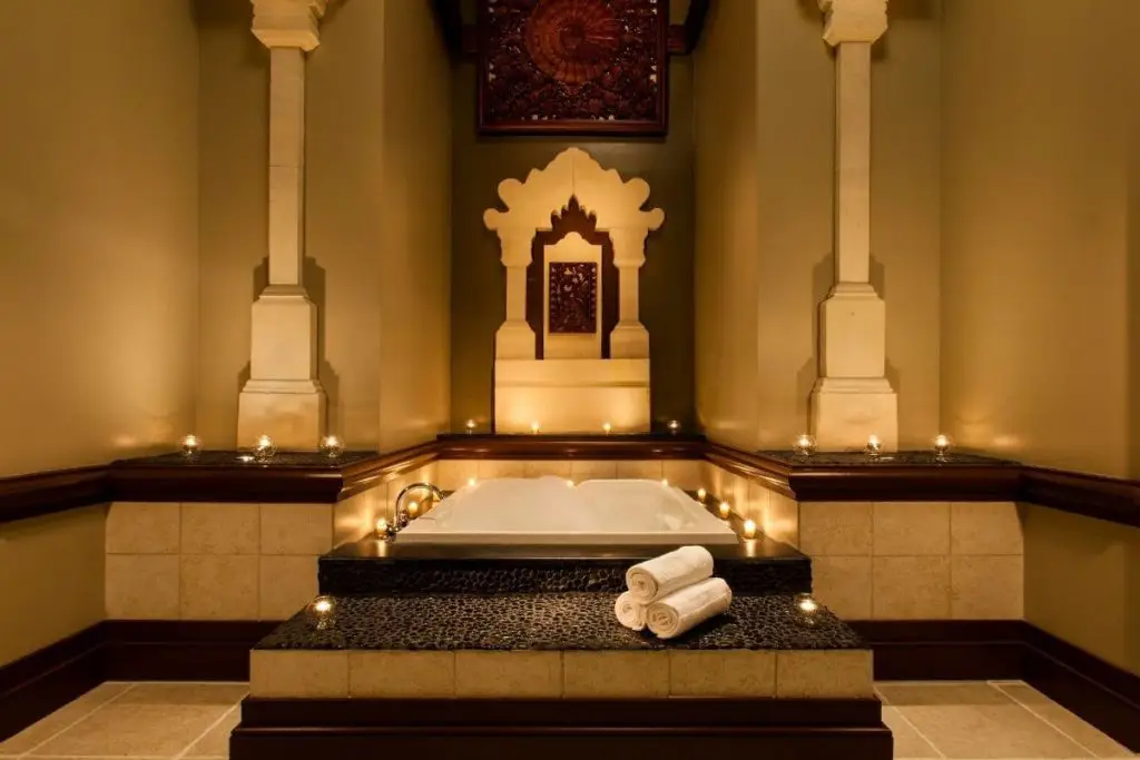 Photo of a candlelit bath at a spa.