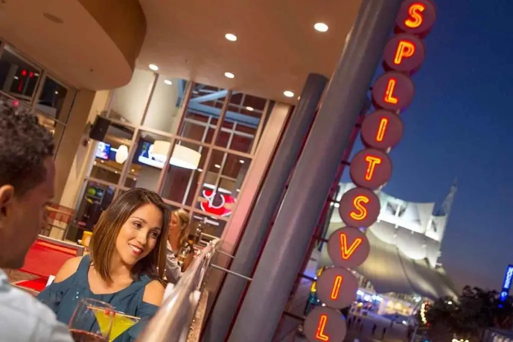 Closeup of a couple dining on the balcony at Splitsville entertainment complex.