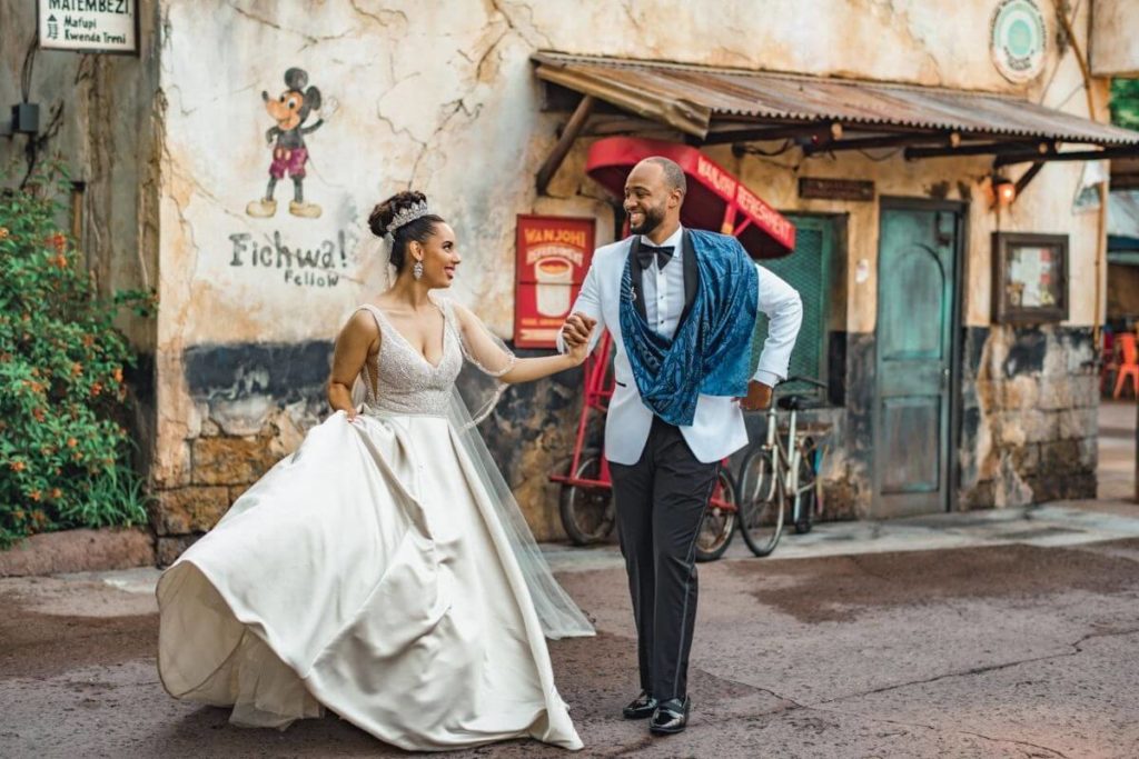 A bride and groom dance in a walkway in Disney World's Animal Kingdom theme park.