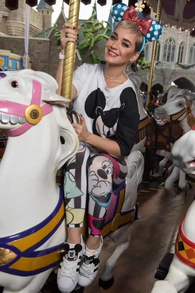 Photo of celebrity Katy Perry riding the carousel at Disney World.