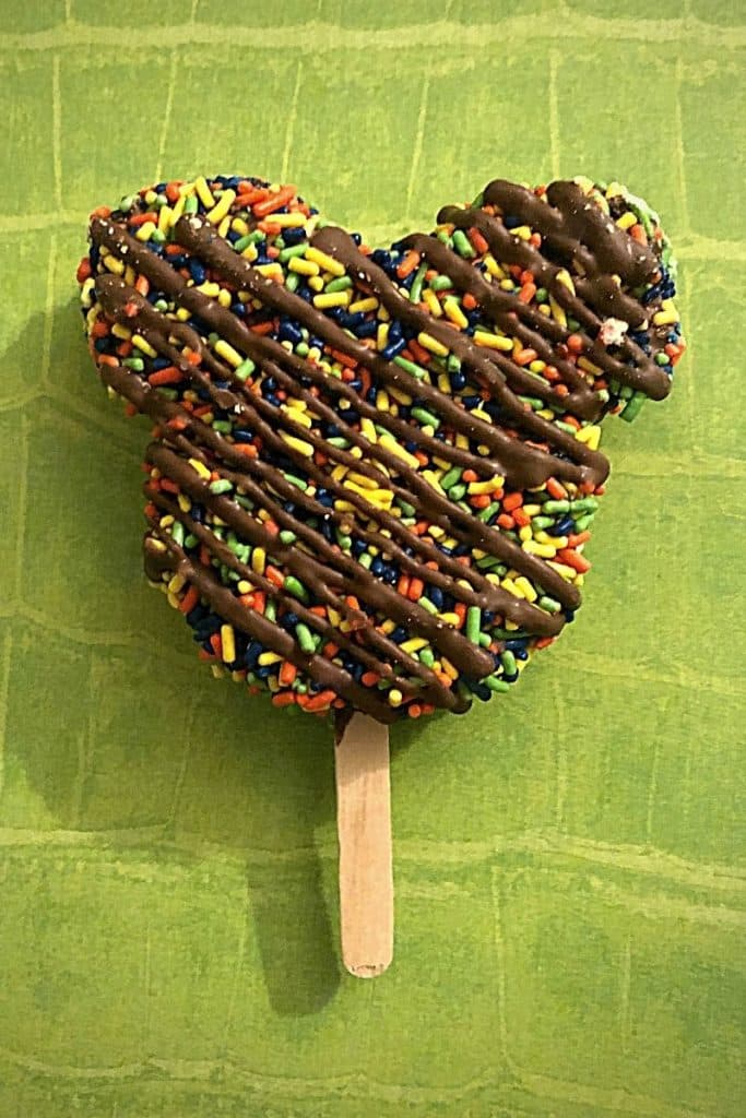 Closeup of a candy coated rice krispy treat shaped like a Mickey Mouse head.