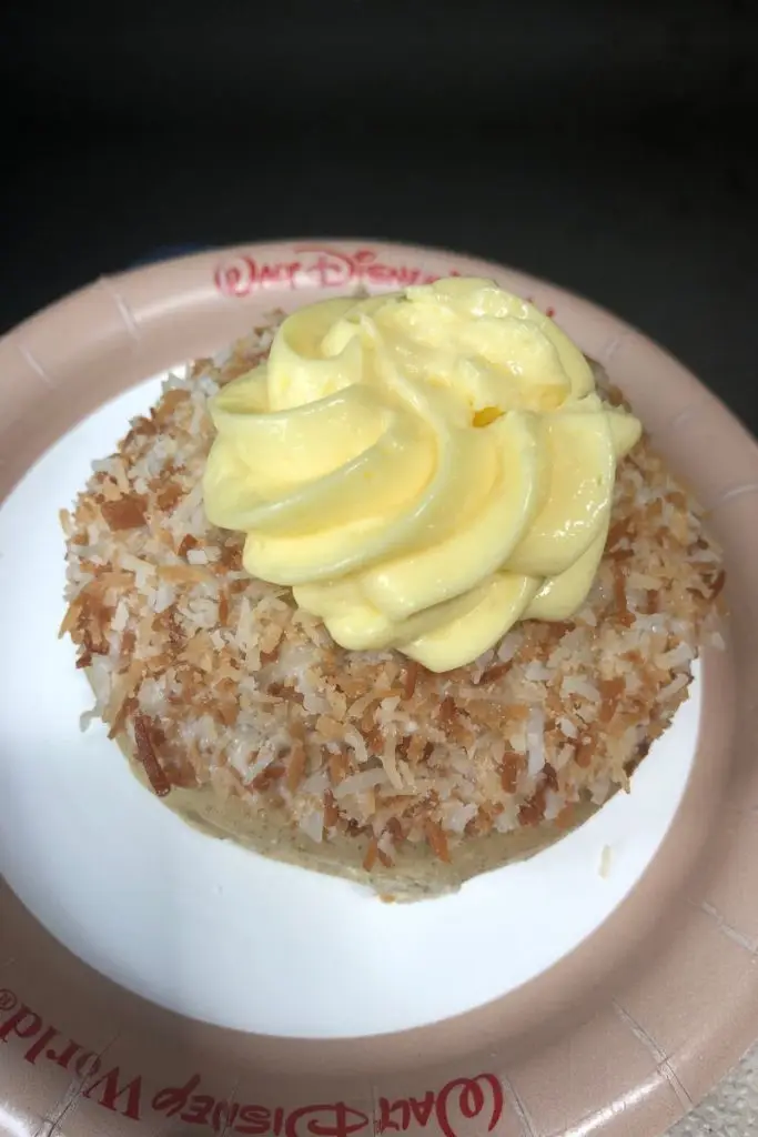 Closeup of Norwegian School Bread topped with custard and toasted coconut.