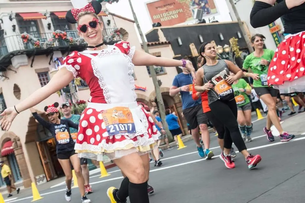 Photo of a woman running in a Minnie Mouse costume at a RunDisney race at Disney World.