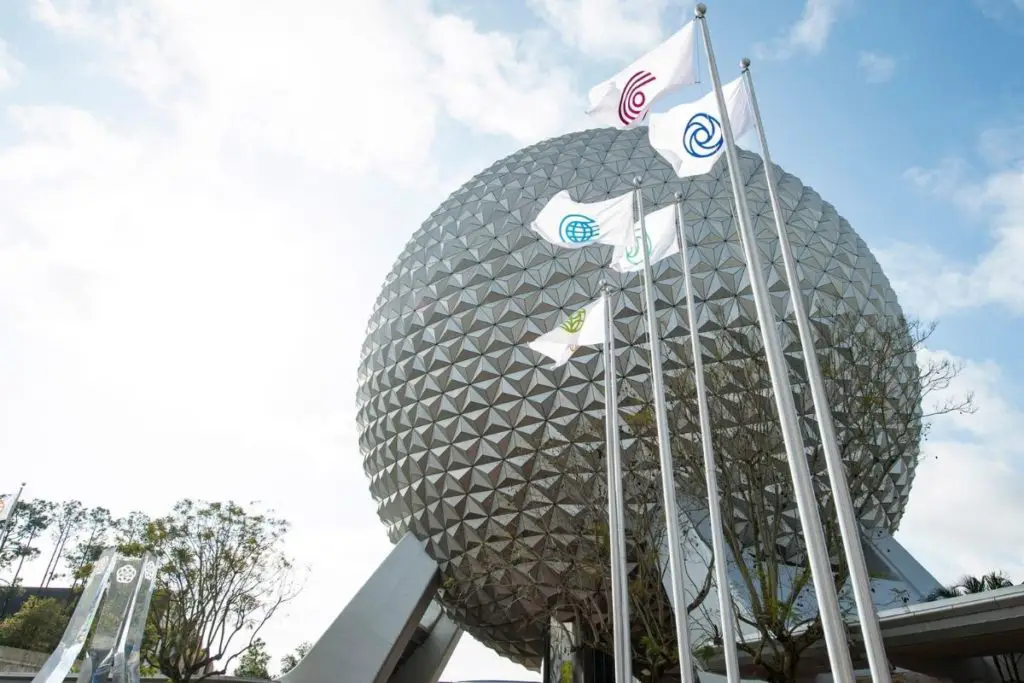 Photo of Spaceship Earth with the new World flags flying in front of it.