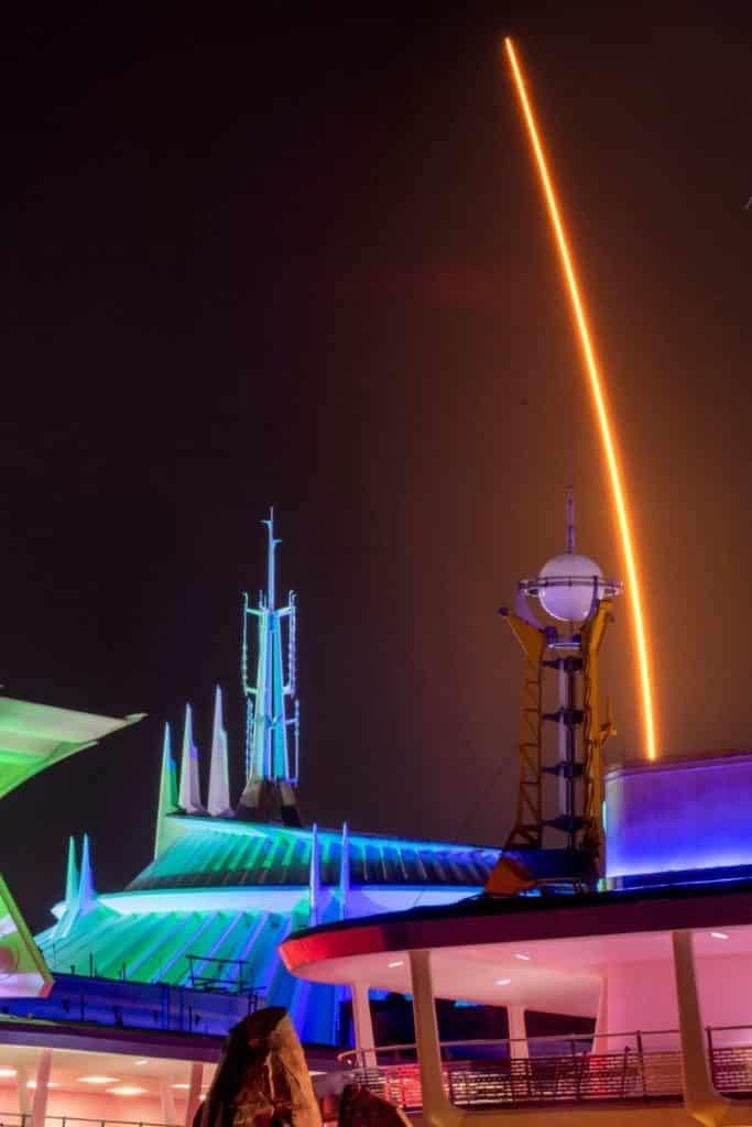 Photo of Tomorrowland at Magic Kingdom at night with lots of neon lights lit up.