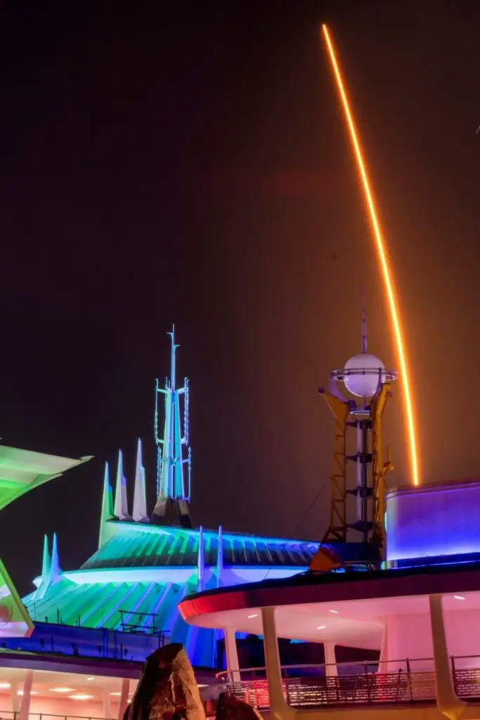 Photo of Tomorrowland at Magic Kingdom at night with lots of neon lights lit up.