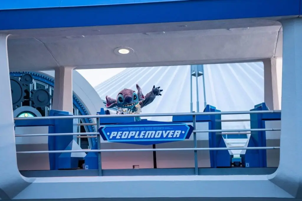 Photo of Stitch riding the PeopleMover ride at Magic Kingdom.