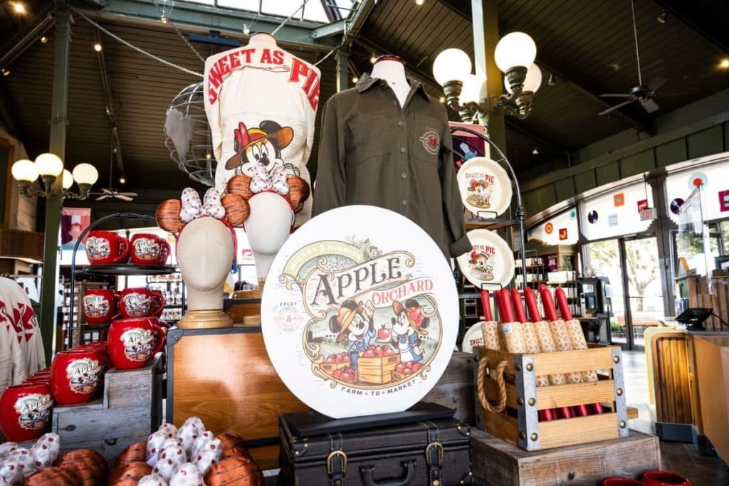 Photograph of an Epcot Food & Wine merchandise display, including Epcot Food & Wine shirts, mugs, rolling pins, ears, and more.