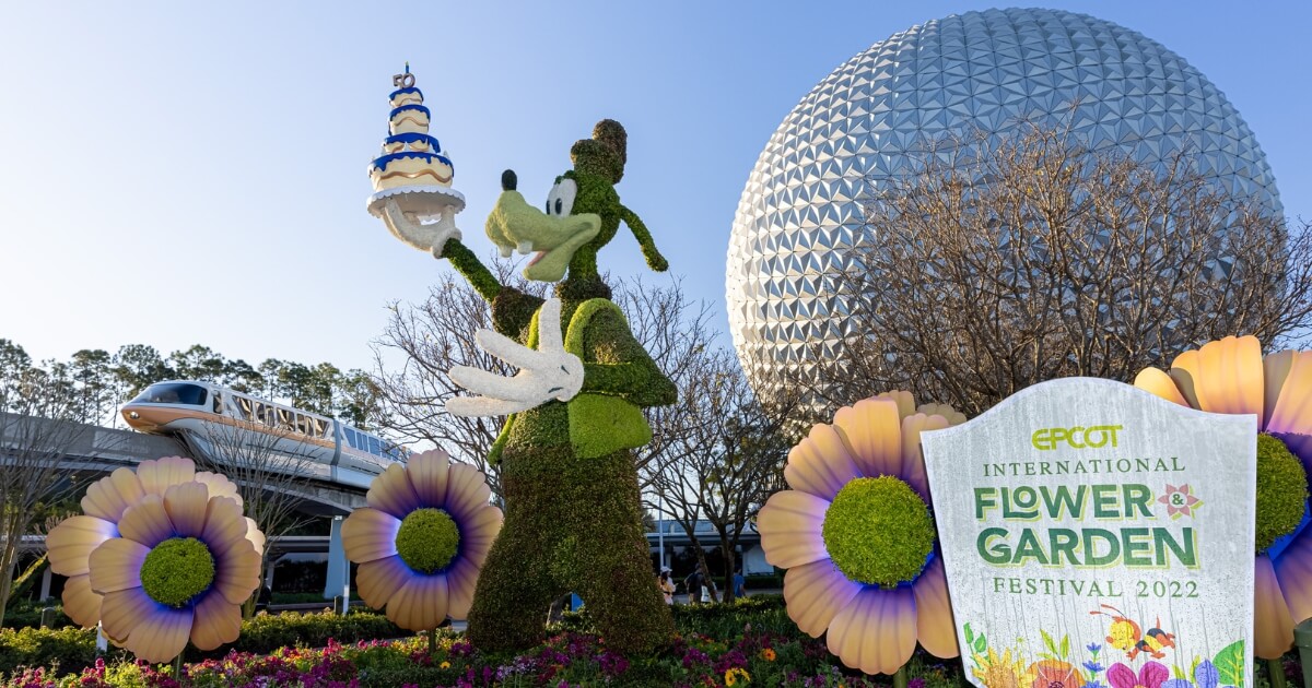 Photo of the Epcot Flower & Garden Festival signage outside the main entrance with Spaceship Earth and the monorail in the background.