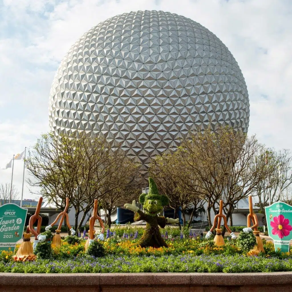 Photo of the Epcot entrance with topiary displays for the Epcot Flower & Garden Festival.