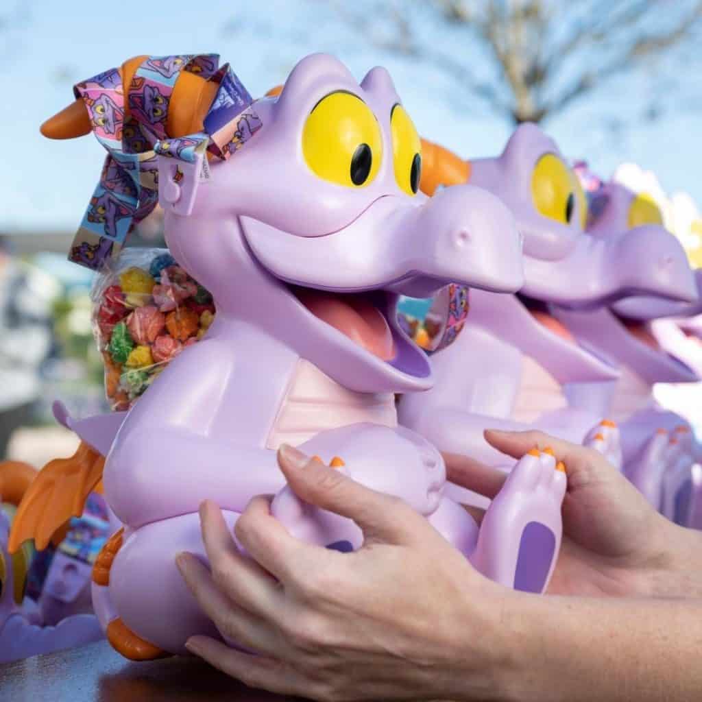 Photo of a row of the elusive Figment popcorn bucket from Epcot.