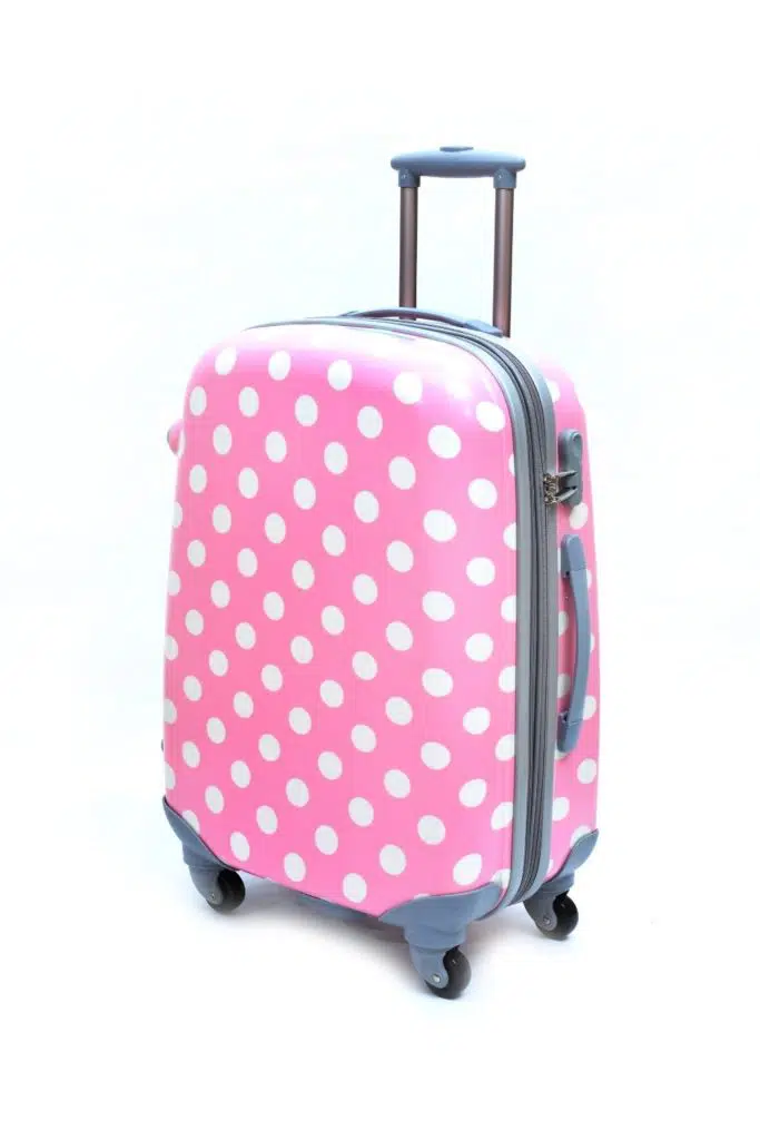 Photo of a pink polka dot suitcase.