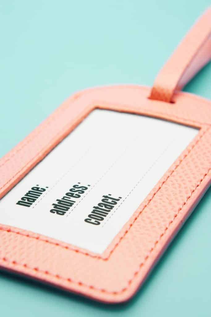 Closeup photo of a pink luggage tag.