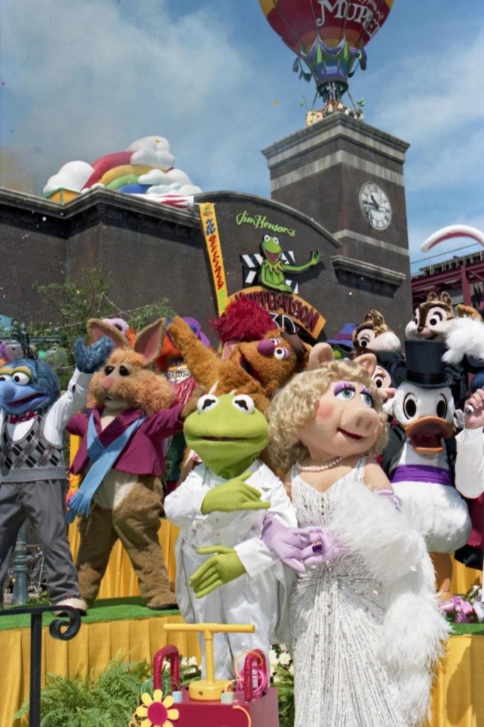 Photo of Muppet characters standing outside the Muppet*Vision 3D show building at Hollywood Studios in Florida.