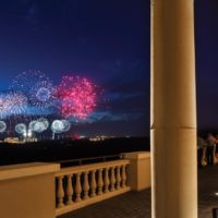 Photo from a balcony at Four Seasons Orlando at night with Disney World fireworks in the distance.