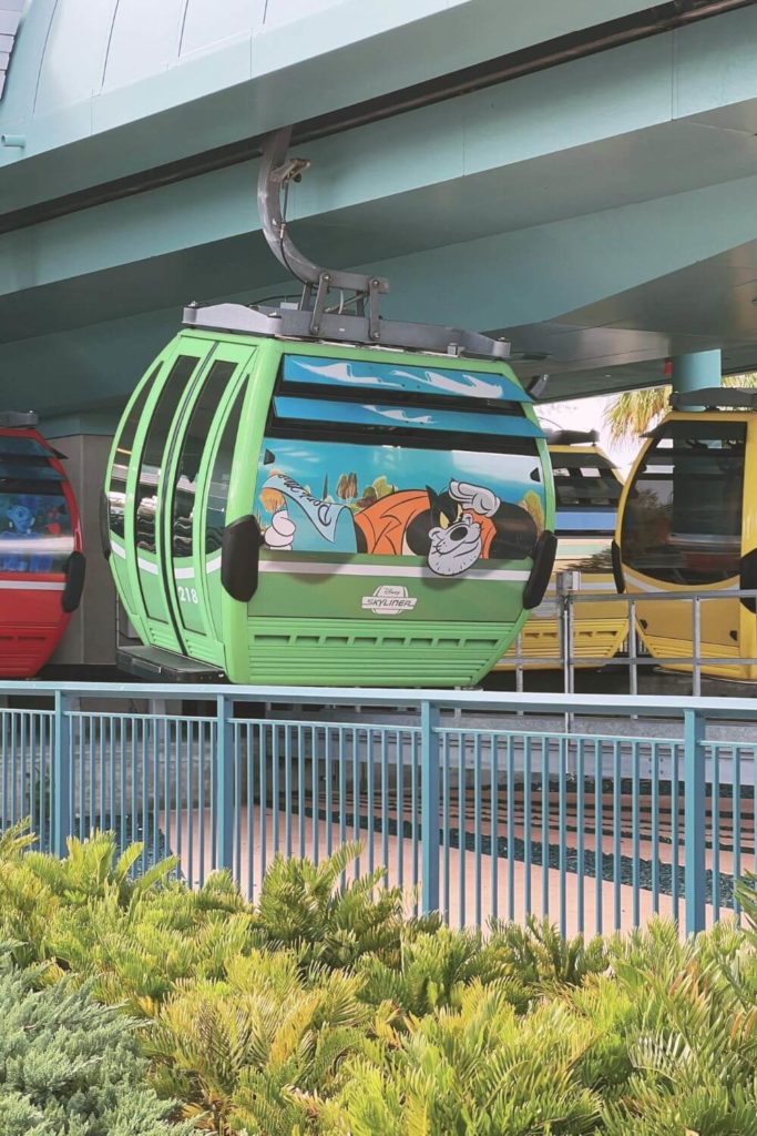 Closeup of a Disney Skyliner gondola cabin adorned with Pete from Mickey Mouse Clubhouse and Goof Troop.