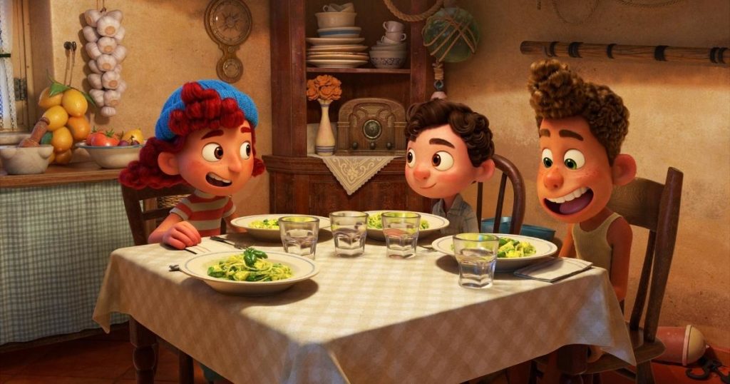 Promotional still from Disney & Pixar's Luca featuring Giulia, Alberto & Luca having a pasta dinner.