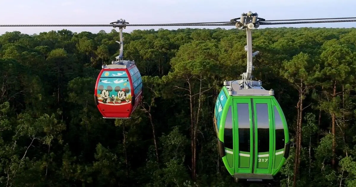 Photo of the Skyliner transportation system running across Hourglass Lake between the Art of Animation and POP Century resorts at Disney World.