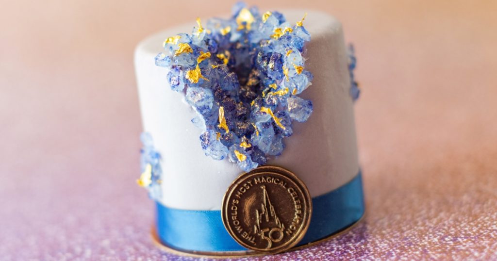 Photo of a small fondant-covered cake from Amorette's Patisserie, designed for Walt Disney World's 50th Celebration.