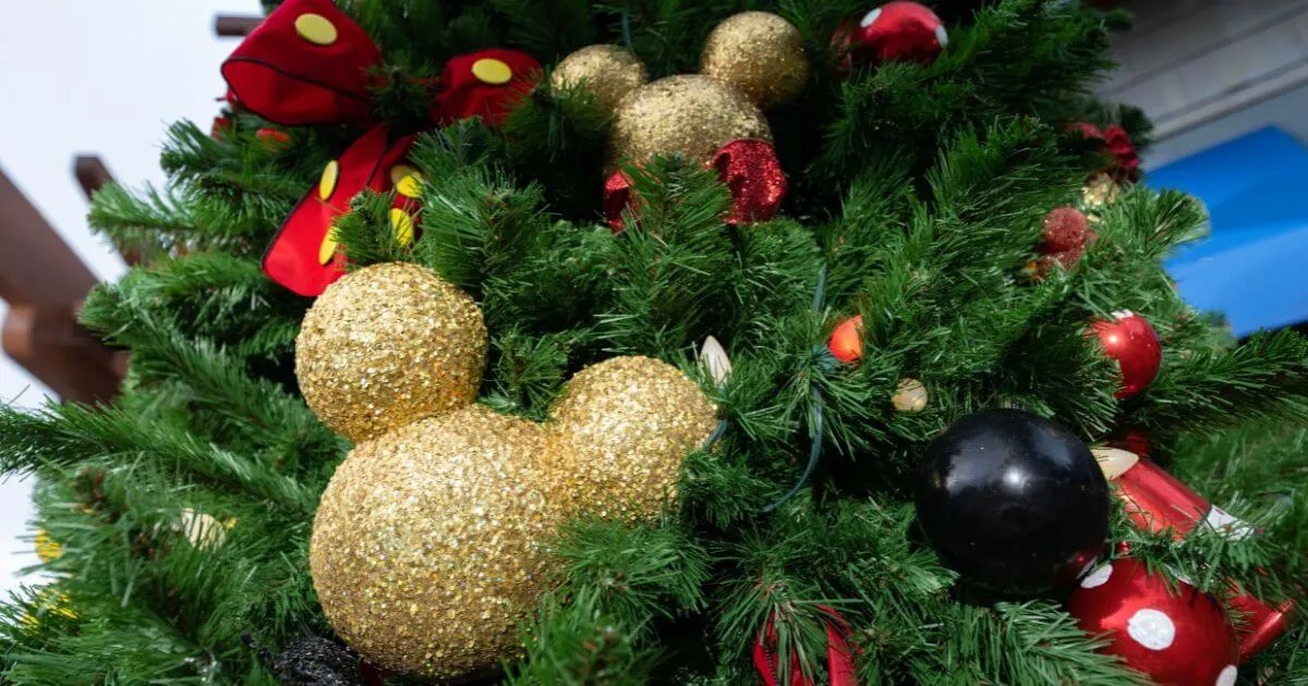 Closeup of a Christmas tree with Minnie and Mickey Mouse themed ornaments.
