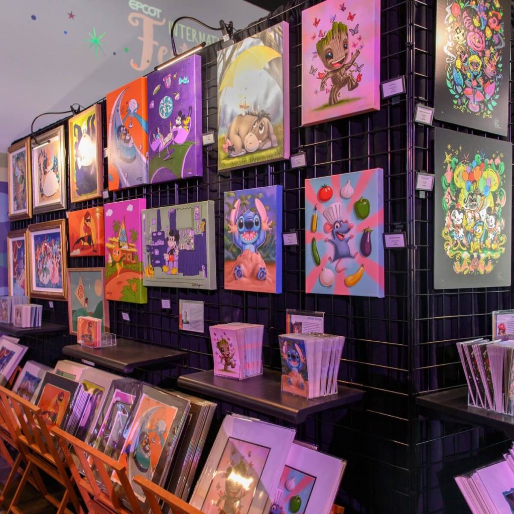 Photo of a display of Disney art prints and paintings for sale.