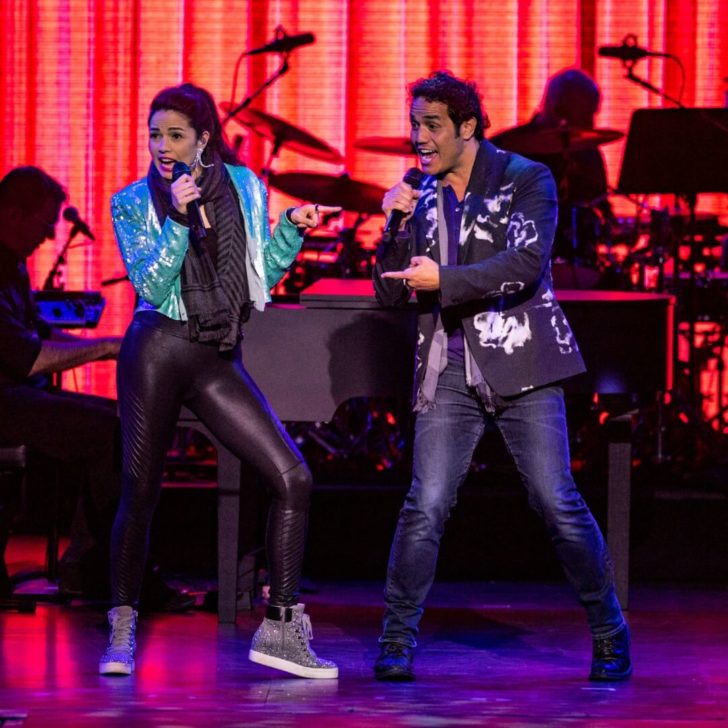 Photo of two performers on stage at the Disney on Broadway concert series at the Epcot International Festival of the Arts.