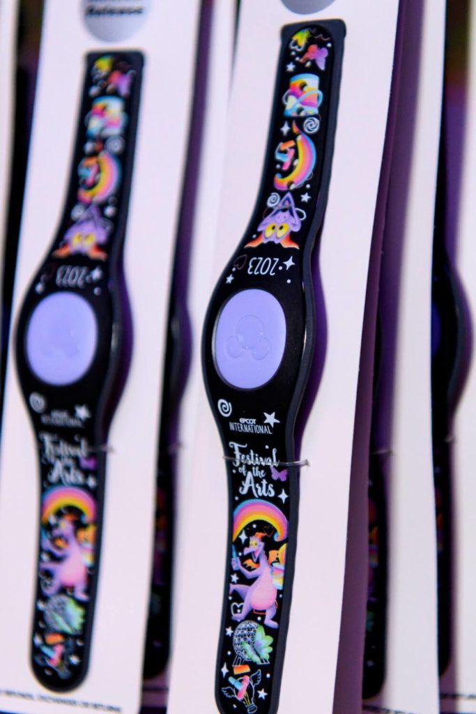 Closeup of the 2023 Epcot International Festival of the Arts MagicBand+ featuring Figment.