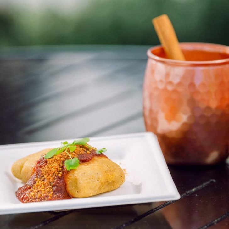 Closeup of the Impossible chorizo tamale and a copper mule mug in the background.