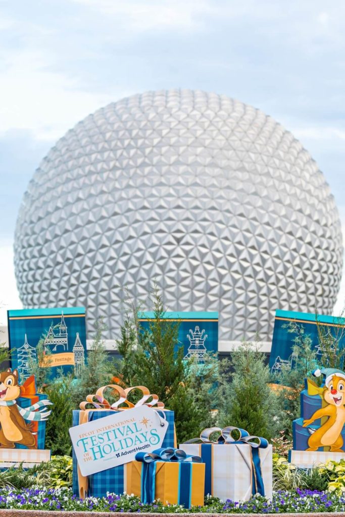 Photo of Spaceship Earth at Epcot with signage for the Epcot International Festival of the Holidays in the foreground.