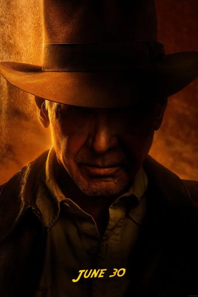 Promotional poster for the film Indiana Jones and the Dial of Destiny featuring a closeup photo of Harrison Ford as Indiana Jones.
