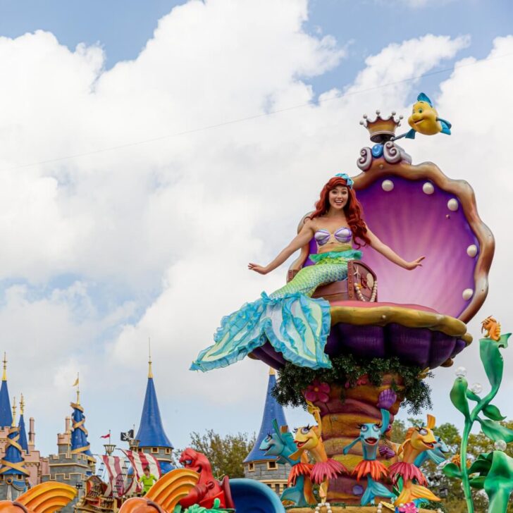 Photo of Princess Ariel sitting in a clamshell shaped chair atop a float as part of Magic Kingdom's Festival of Fantasy parade.