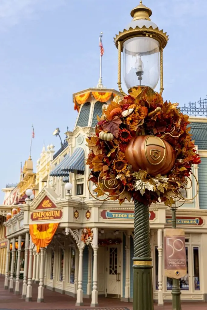 Photo of a lamp post on Main Street in Magic Kingdom at Disney World with a Fall floral display attached.