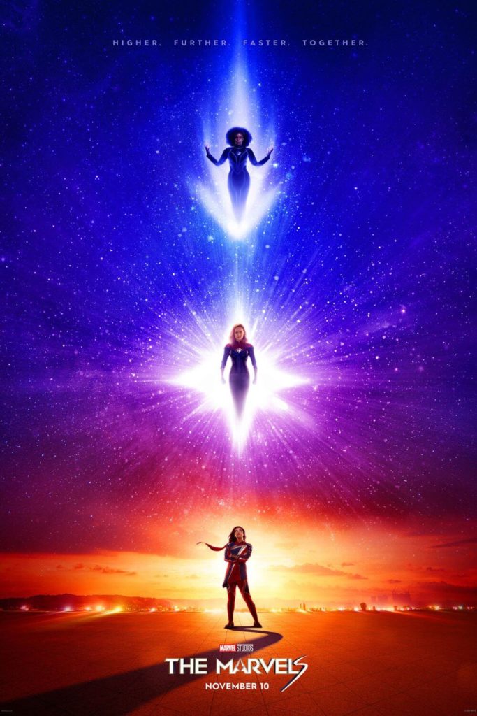 Promotional poster for The Marvels, featuring a vertical image of the 3 main characters, Kamala Khan, Carol Danvers, and Monica Rambeau. Above the image it says "Higher. Further. Faster. Together."