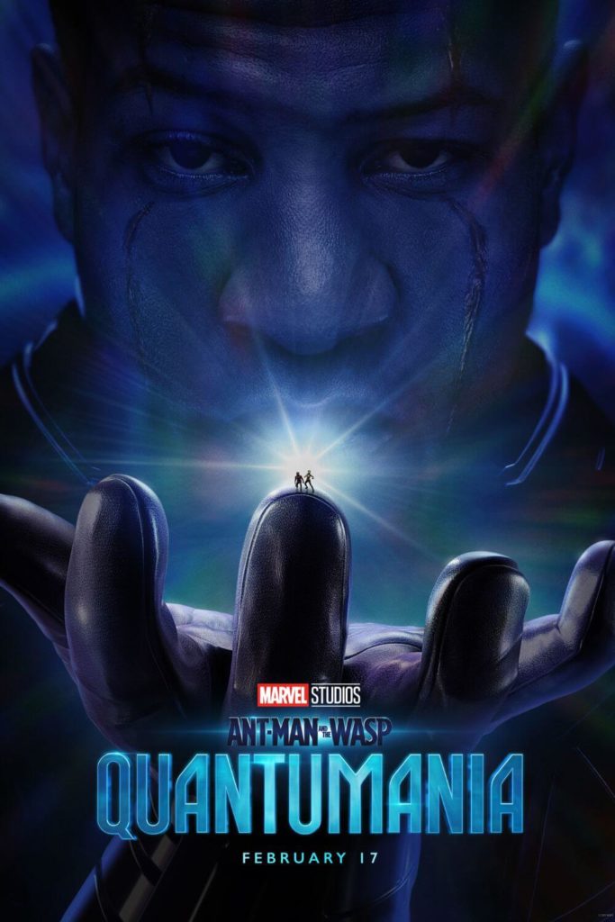 Promotional poster for the movie "Ant-Man and the Wasp: Quantumania" featuring Kang the Conqueror with 2 ant-sized characters perched on top of one of his fingers.