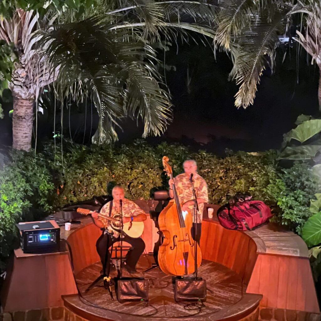 Photo of 2 musicians performing at night at Aulani Resort in Hawaii.