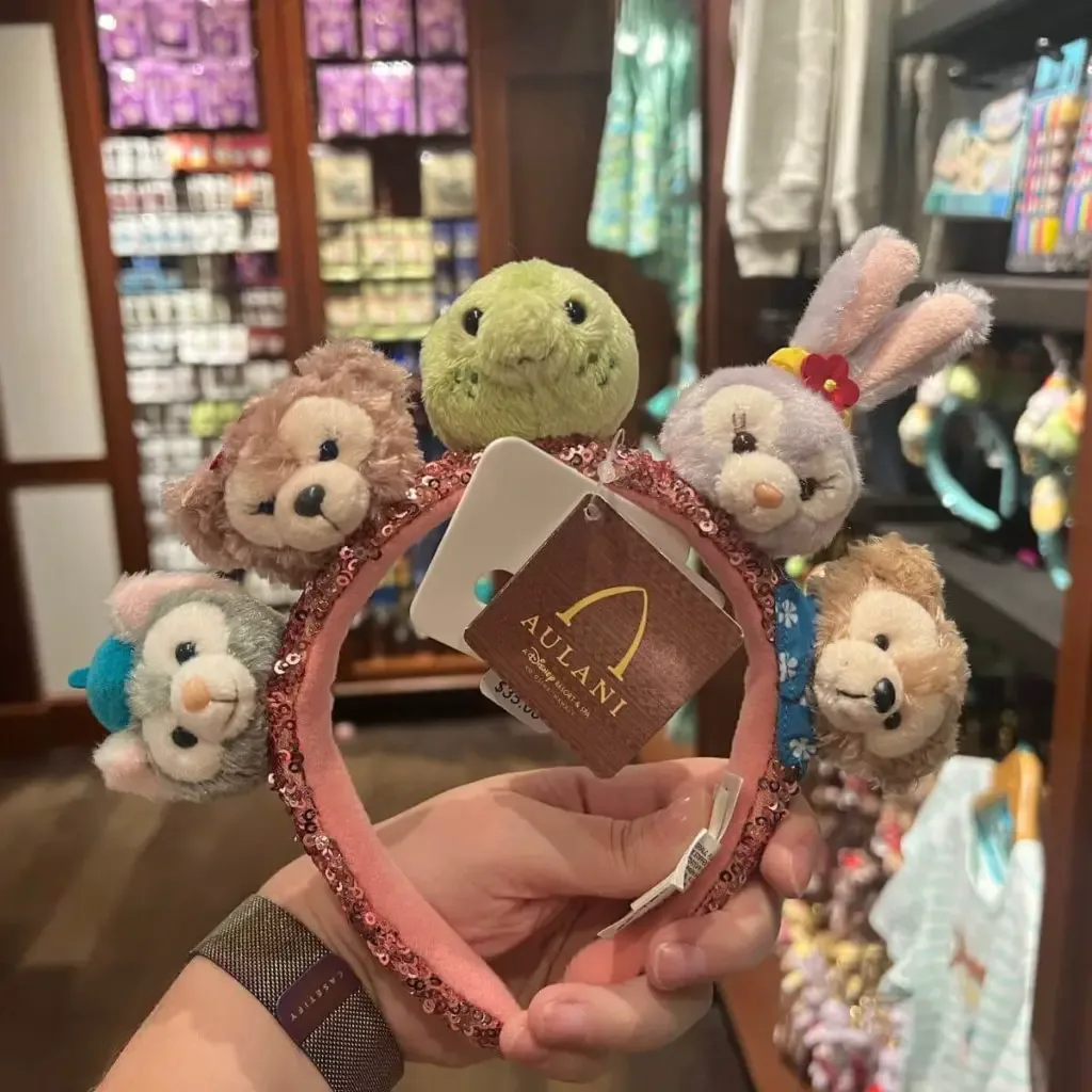 Closeup of a headband with Duffy the Bear and friends on it.