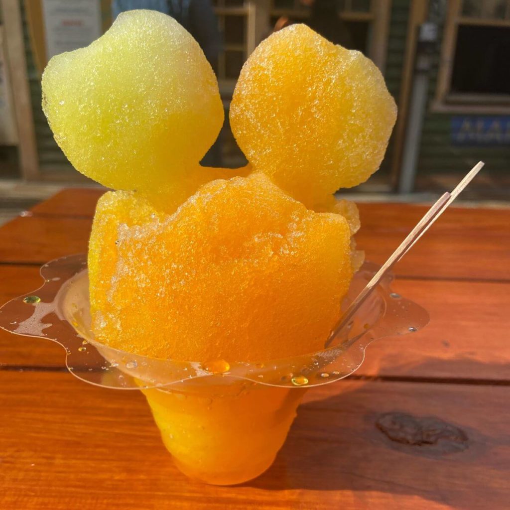 Closeup photo of Mickey-shaped shave ice with lilikoi (passionfruit) and banana yellow flavors.