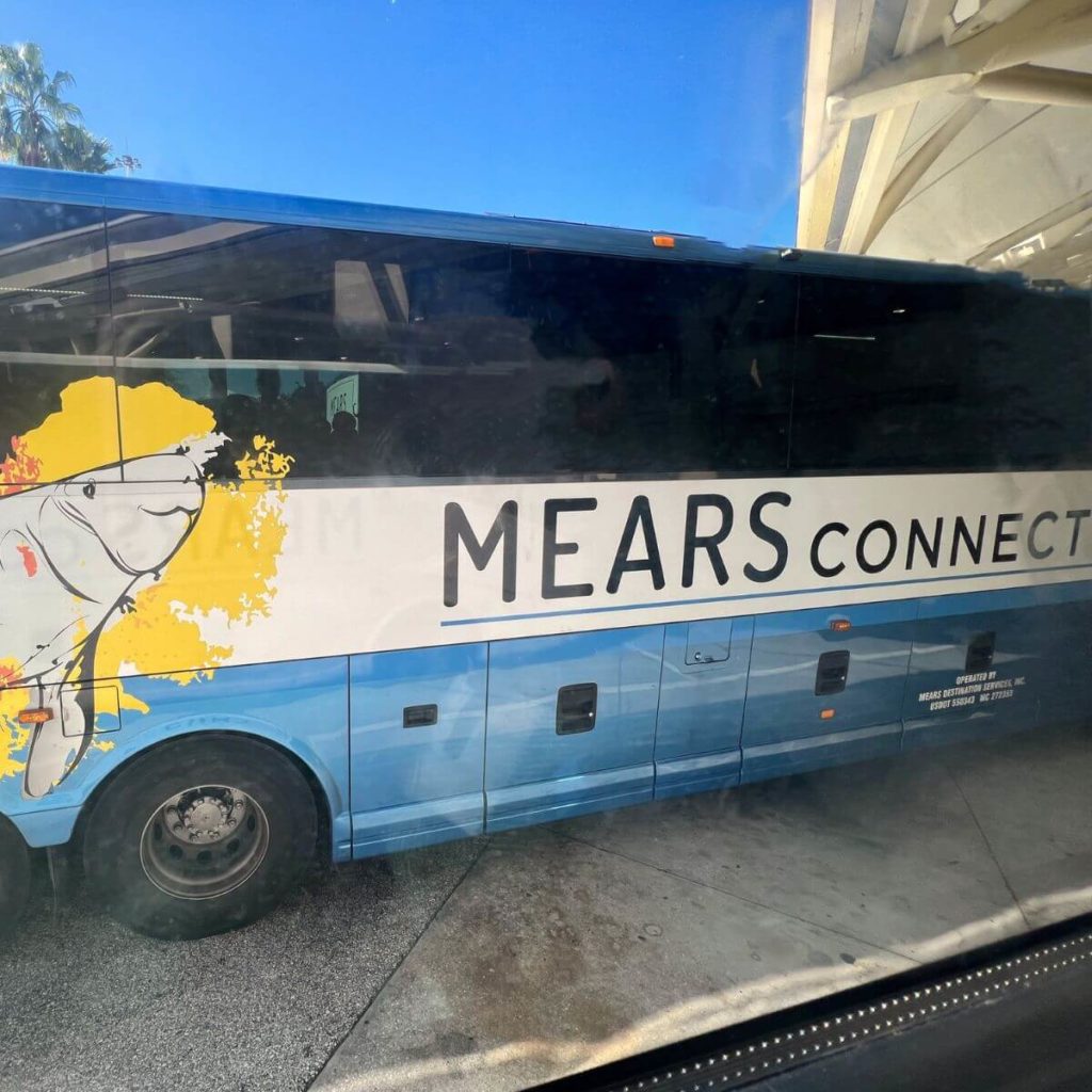 Photo of a MEARS Connect coach bus with a manatee graphic on the side.