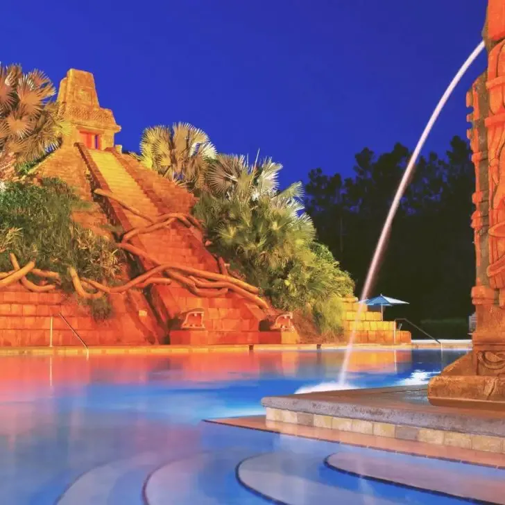 Photo of the pool area, including a replica of a Mayan temple, at night at Coronado Springs Resort.