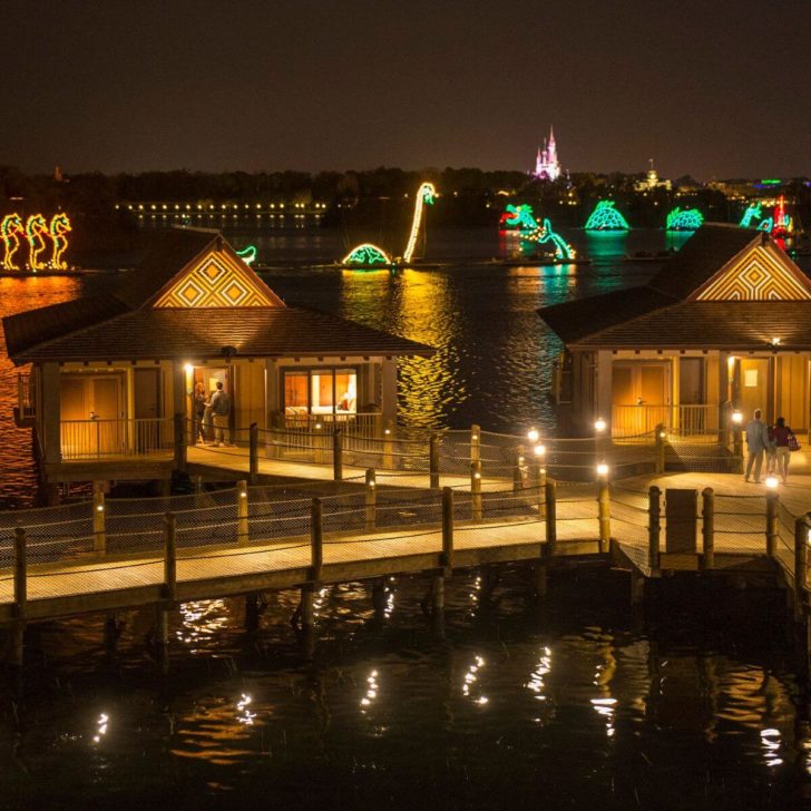 Photo of the Electical Water Pageant from the Polynesian Bungalows, with Cinderella's Castle in the background.