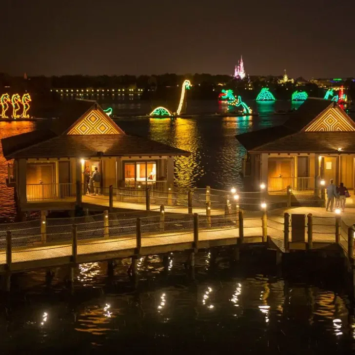 Photo of the Electical Water Pageant from the Polynesian Bungalows, with Cinderella's Castle in the background.