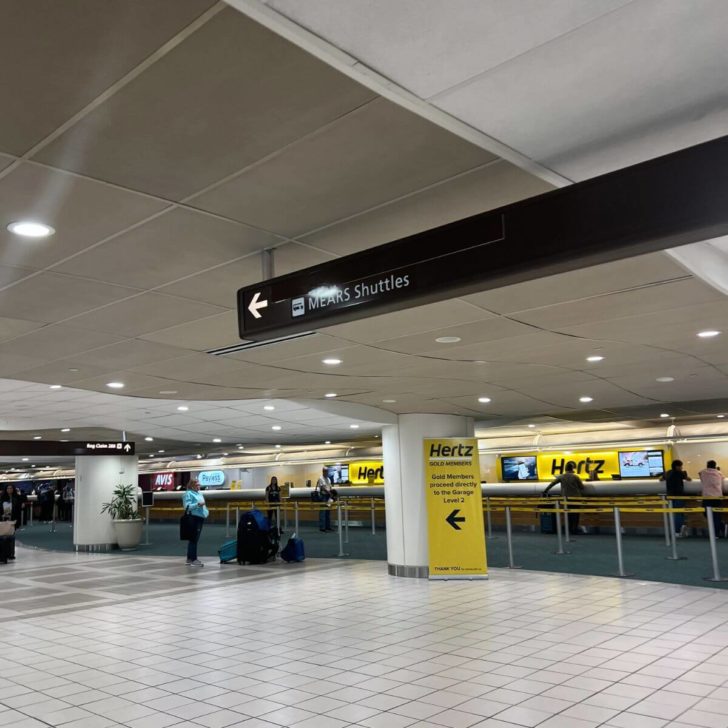 Photo of a sign pointing to the MEARS Shuttles at MCO airport.