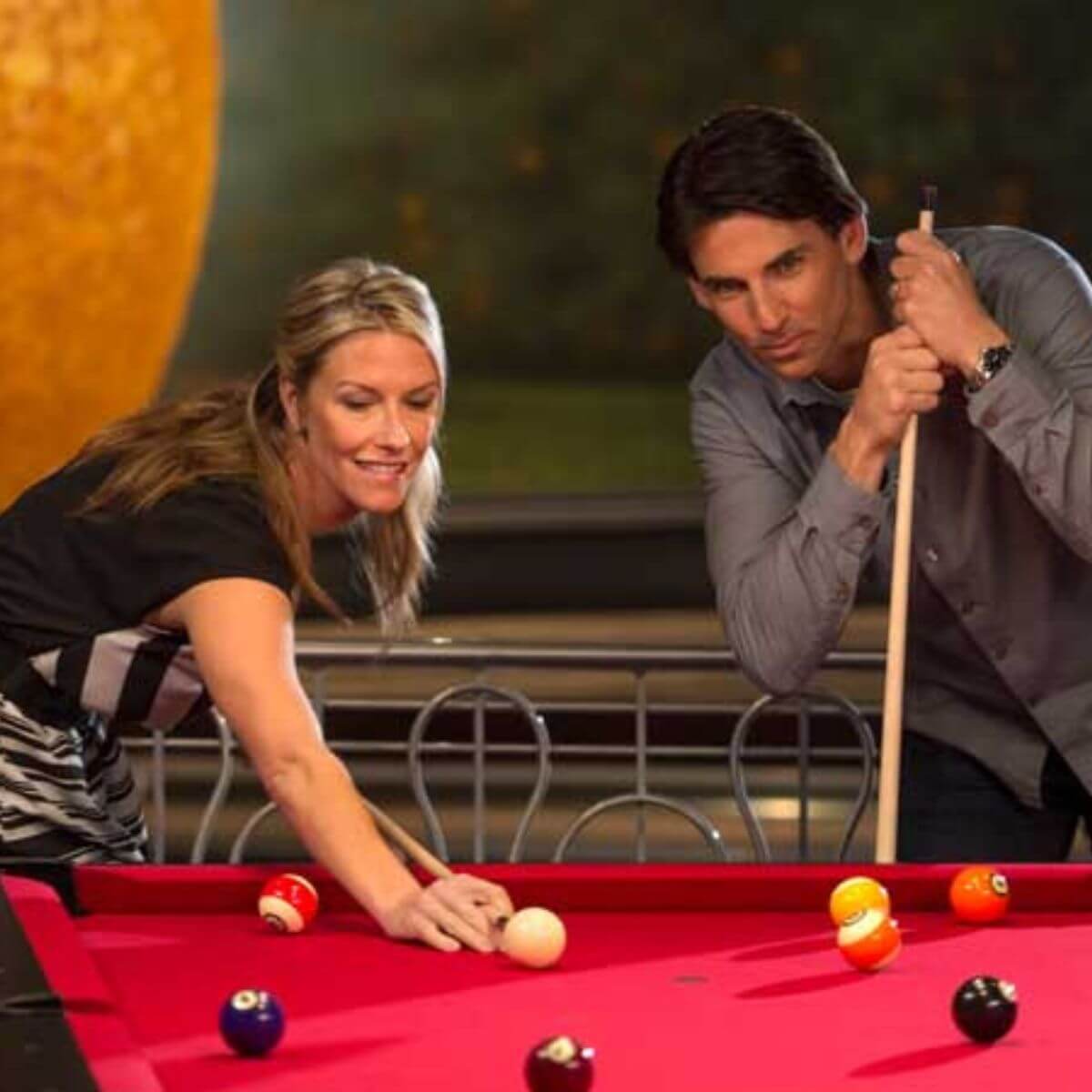 Photo of a man and woman playing billiards at Splitsville in Disney Springs.